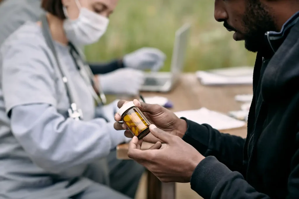 young sick man holding bottle with pills prescribe 2023 11 27 05 22 59 utc