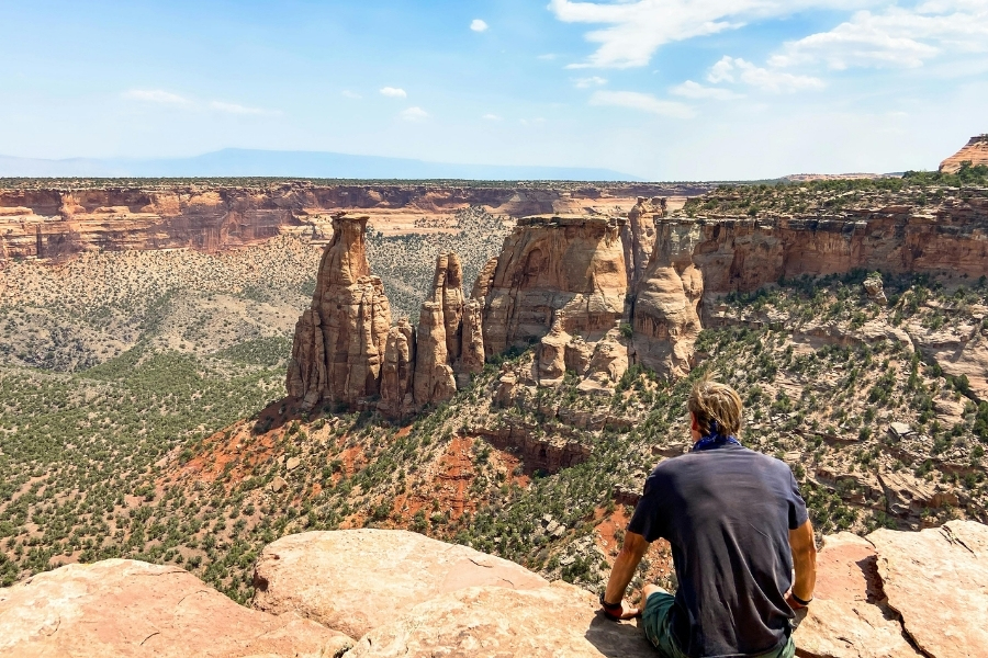 man looking out on arizona canyon