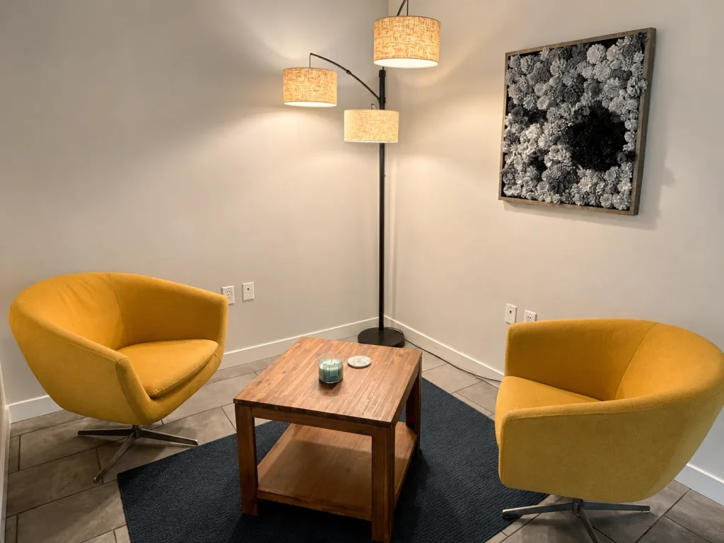 Therapy room with two yellow armchairs and a side table