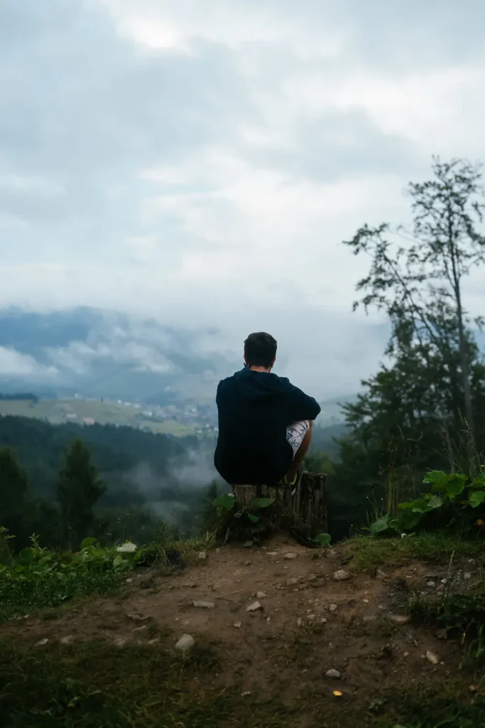 Man looking out over the landscape during 7-OH recovery at Guiding Road