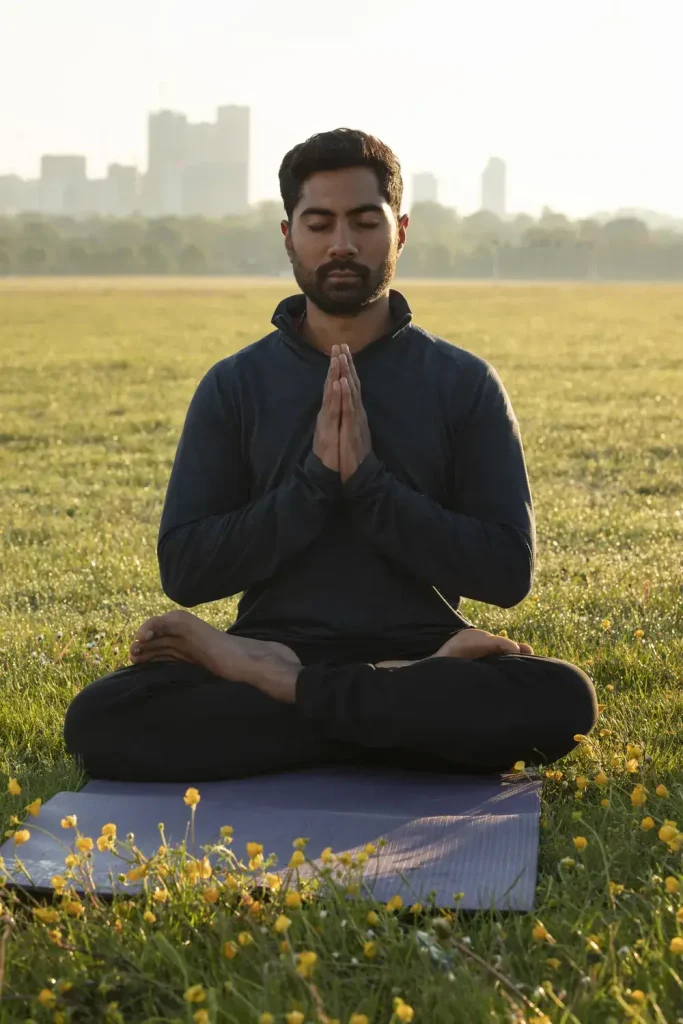 Man meditating outdoors, mind body and spirit care at Guiding Road