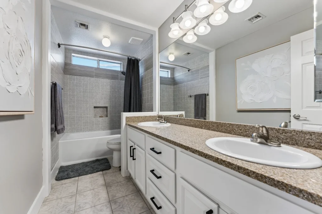 Bathroom with a shower and tub combination and a vanity
