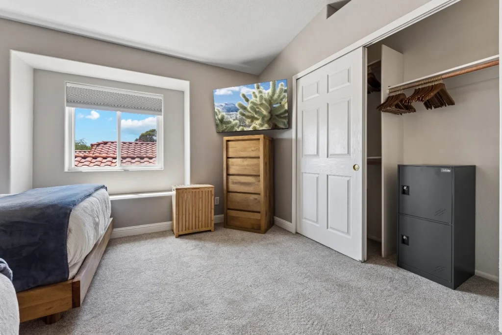 Bedroom with a bed, dresser, and window